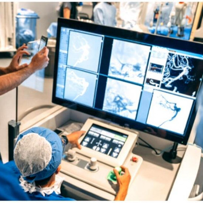 In a world first, Toronto surgeon Dr. Vitor Pereira operates a robotic surgical system during an operation on a woman with a large aneurysm. 