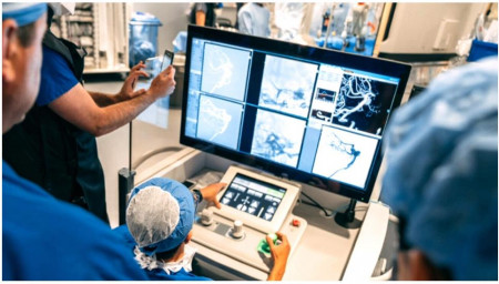In a world first, Toronto surgeon Dr. Vitor Pereira operates a robotic surgical system during an operation on a woman with a large aneurysm. 